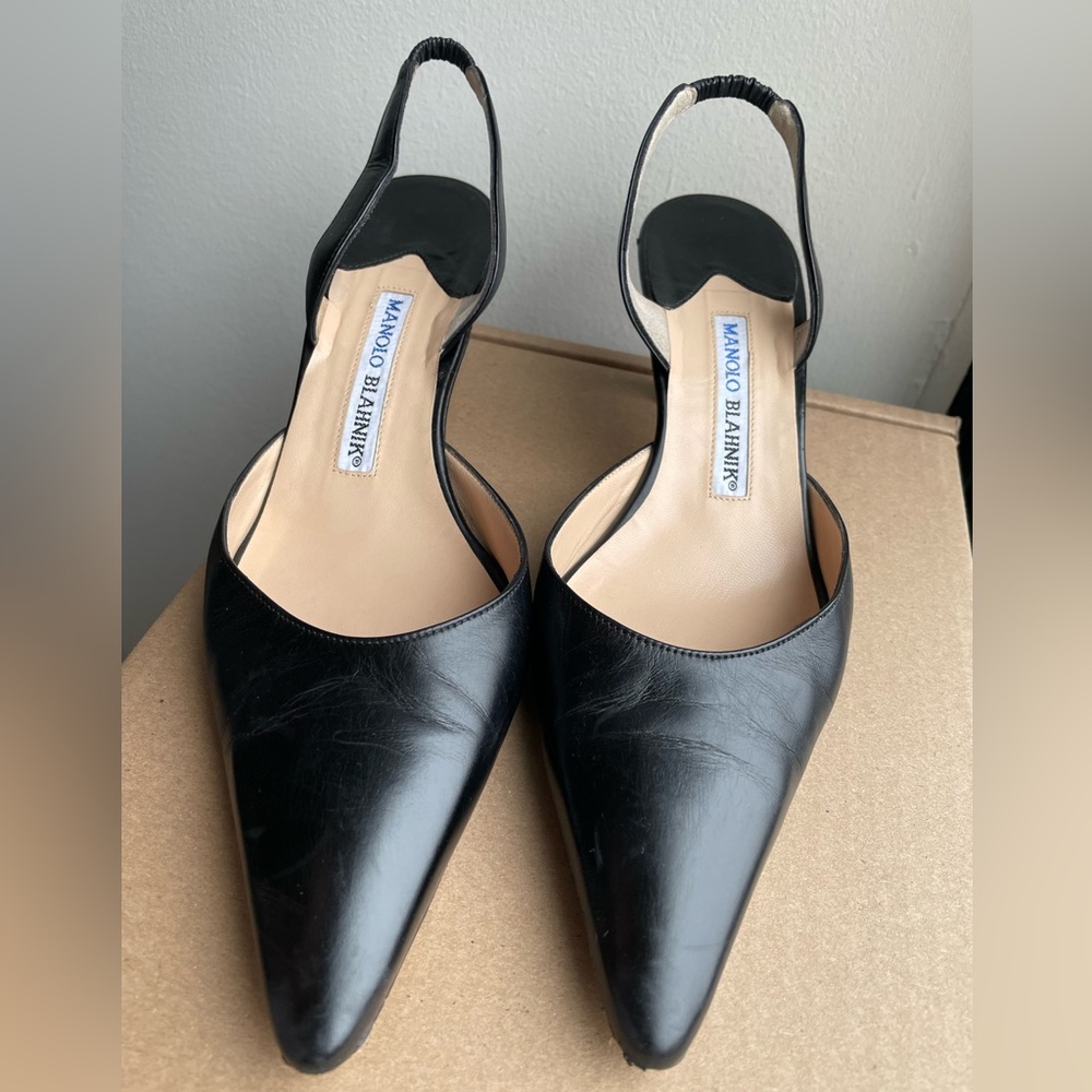 Black leather Manolo Blahnik Carolyne slingback pumps with a low, kitten heel.